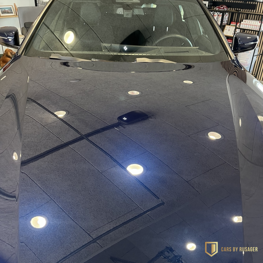 bmw-i4-tanzanite-blue-lakfinish-motorhjelm Nærbillede af fronten på BMW i4 xDrive40 M Sport med den karakteristiske BMW-nyregrill og dyb glans i lakken.